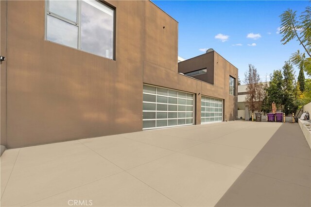 9 Temple Ave, Long Beach, CA 90803 - view of home's exterior with a garage, concrete driveway, and stucco siding
