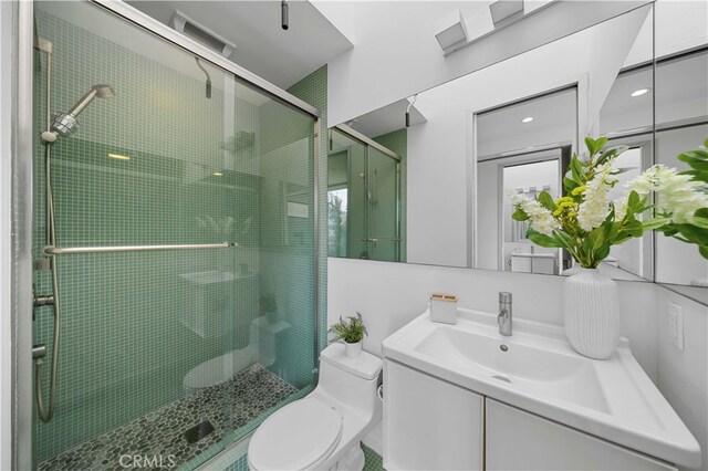 9 Temple Ave, Long Beach, CA 90803 - bathroom featuring visible vents, vanity, a shower stall, and toilet