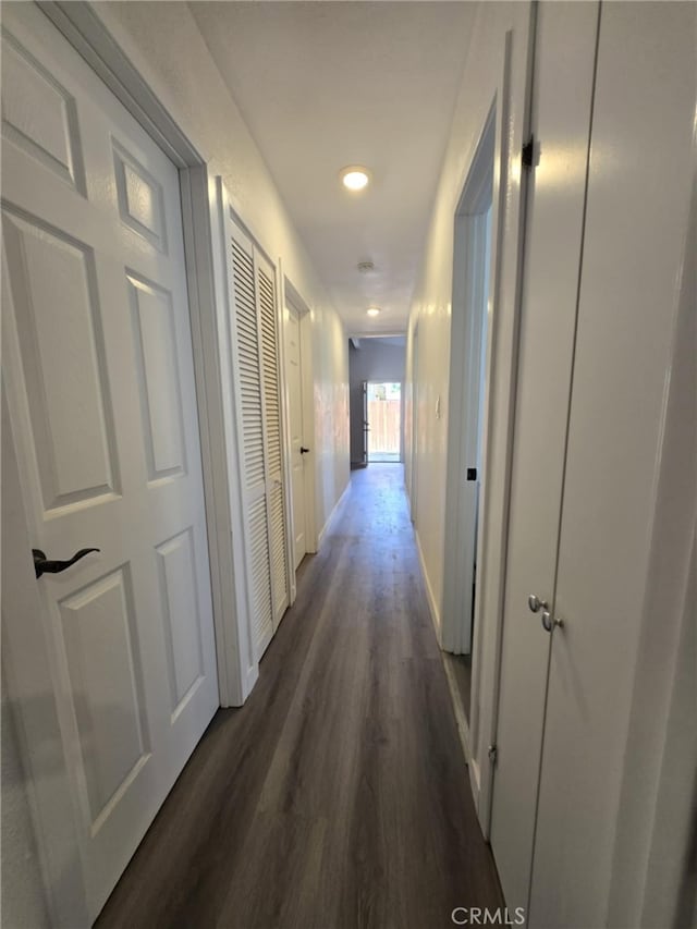 corridor featuring recessed lighting, baseboards, and dark wood-style floors
