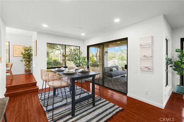 dining area with baseboards, recessed lighting, and wood finished floors