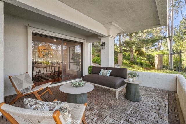 view of patio / terrace with fence and an outdoor hangout area