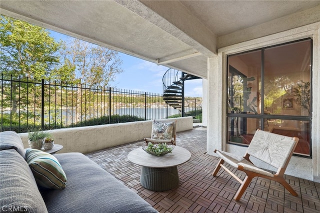 view of patio / terrace with fence, a water view, and stairs