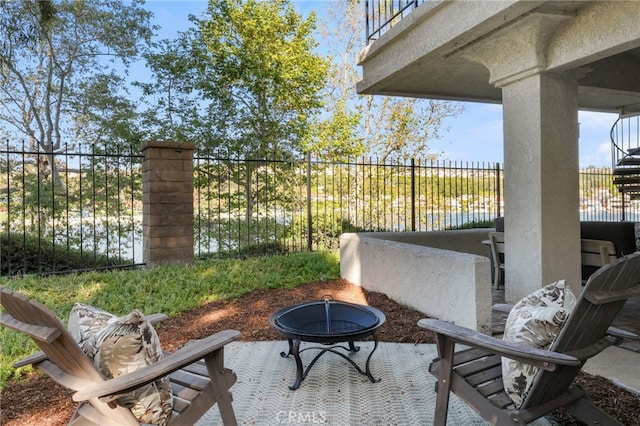 view of patio with fence and an outdoor fire pit