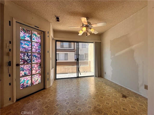 7 Wilderness Pl, Pomona, CA 91766 - empty room with a ceiling fan, a textured ceiling, tile patterned floors, and baseboards