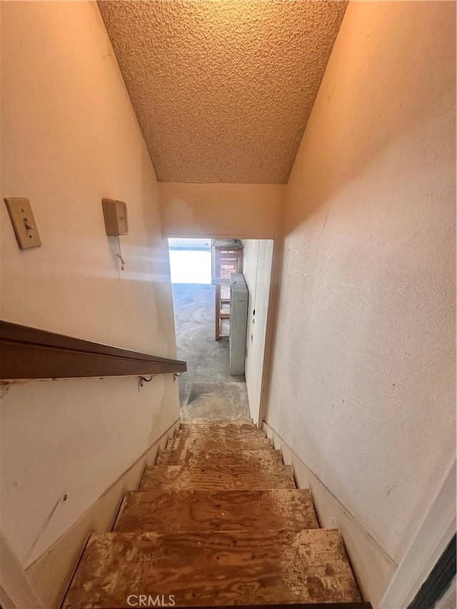 7 Wilderness Pl, Pomona, CA 91766 - staircase with vaulted ceiling and a textured ceiling