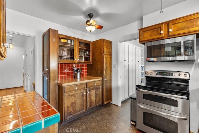 919 W Kenneth Rd, Glendale, CA 91202 - kitchen with stainless steel appliances, tasteful backsplash, a ceiling fan, brown cabinets, and light countertops