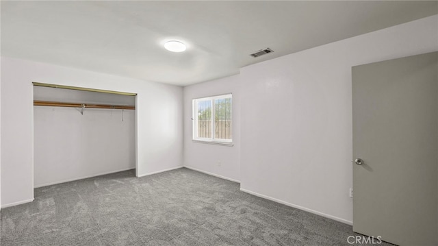 unfurnished bedroom featuring carpet flooring, a closet, and baseboards