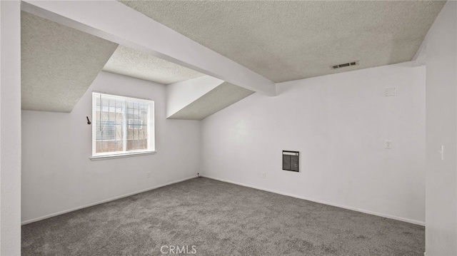 additional living space with a textured ceiling, carpet flooring, and baseboards