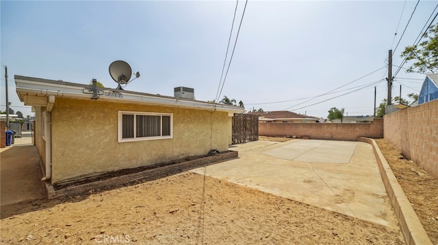 view of home's exterior with a fenced backyard, stucco siding, and a patio