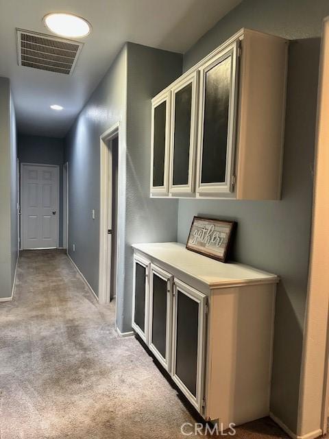 1380 Riverstone Ct, Hemet, CA 92545 - hall featuring baseboards, visible vents, and light colored carpet