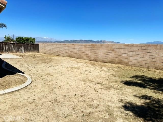 1380 Riverstone Ct, Hemet, CA 92545 - view of yard featuring a fenced backyard and a mountain view