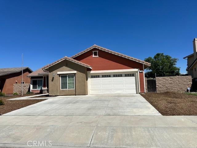 1380 Riverstone Ct, Hemet, CA 92545 - ranch-style house featuring fence, stucco siding, concrete driveway, a tile roof, and a garage