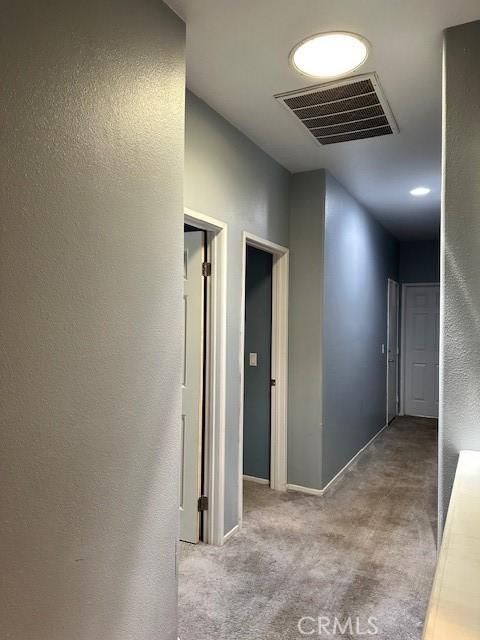 1380 Riverstone Ct, Hemet, CA 92545 - hall with visible vents, carpet flooring, and baseboards
