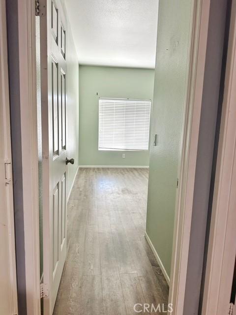 1380 Riverstone Ct, Hemet, CA 92545 - hallway featuring wood-type flooring and baseboards