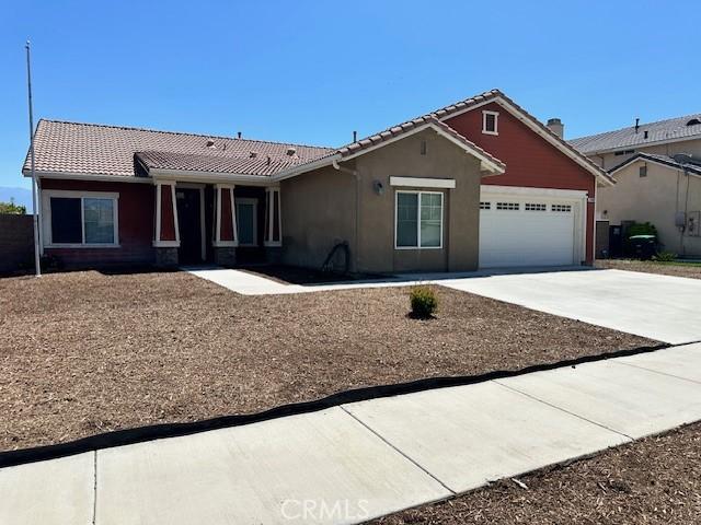1380 Riverstone Ct, Hemet, CA 92545 - ranch-style house featuring stucco siding, a tiled roof, driveway, and a garage