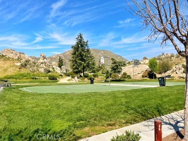 1380 Riverstone Ct, Hemet, CA 92545 - view of home's community with a lawn, a mountain view, and community basketball court