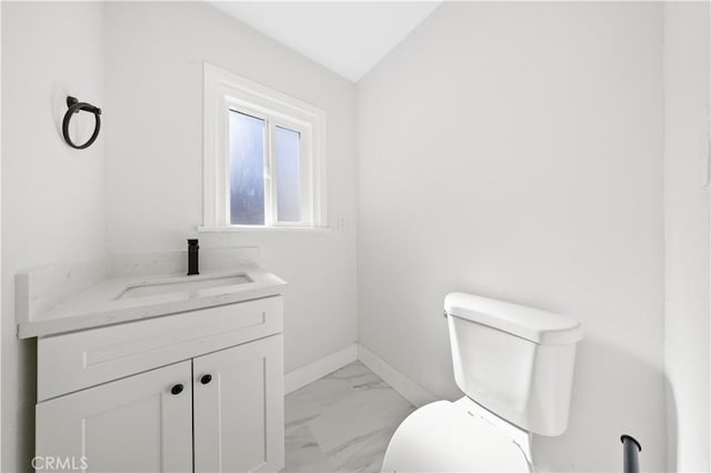 10321 Mcbroom St, Sunland, CA 91040 - half bathroom featuring toilet, vaulted ceiling, baseboards, marble finish floor, and vanity