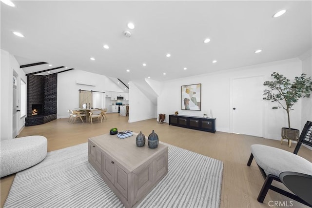10321 Mcbroom St, Sunland, CA 91040 - living room featuring recessed lighting, light wood-style floors, and a brick fireplace