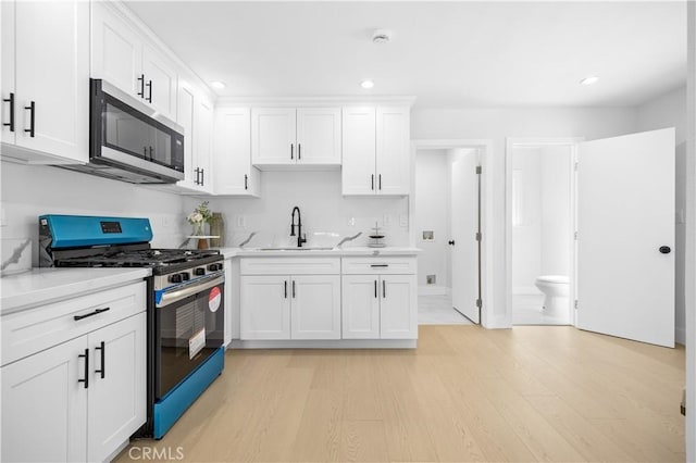 10321 Mcbroom St, Sunland, CA 91040 - kitchen with light countertops, stainless steel appliances, light wood finished floors, and a sink