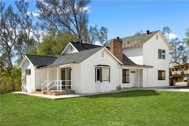 10321 Mcbroom St, Sunland, CA 91040 - rear view of house featuring stucco siding, a yard, a chimney, and fence