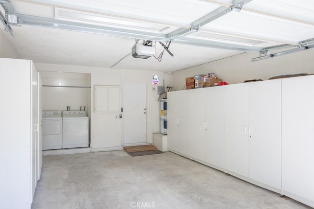 garage with washer and dryer and a garage door opener