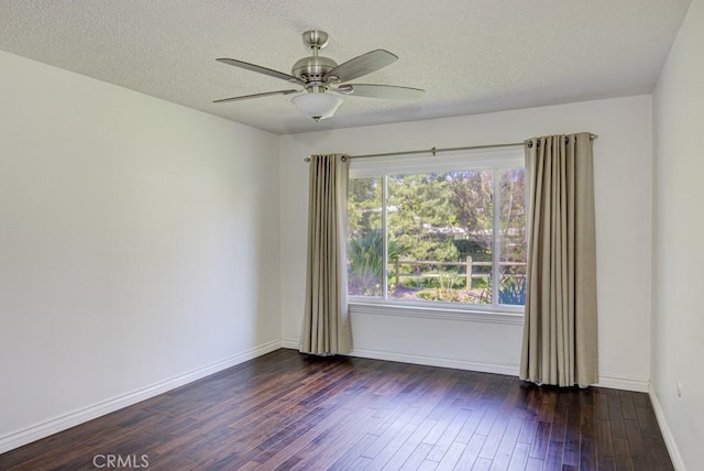 unfurnished room featuring ceiling fan, a textured ceiling, baseboards, and dark wood-style flooring