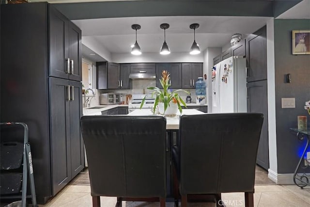 17274 Nisson Rd Unit A, Tustin, CA 92780 - kitchen featuring white appliances, light tile patterned flooring, light countertops, and a kitchen island