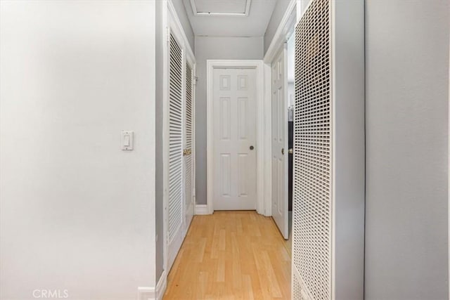 17274 Nisson Rd Unit A, Tustin, CA 92780 - corridor featuring a heating unit, light wood-style flooring, and baseboards