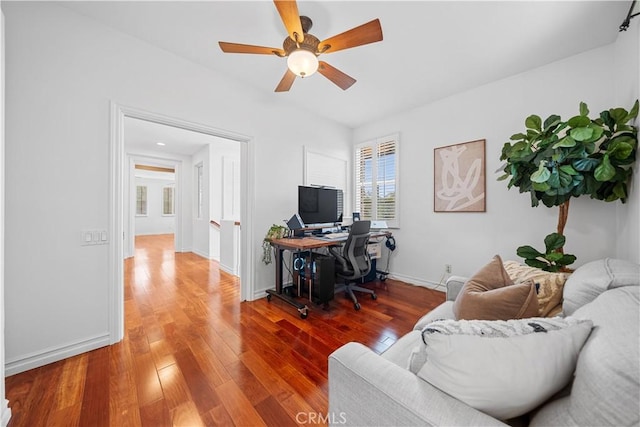 home office with baseboards, wood finished floors, and ceiling fan