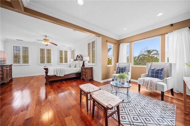 bedroom featuring baseboards, wood finished floors, recessed lighting, and crown molding