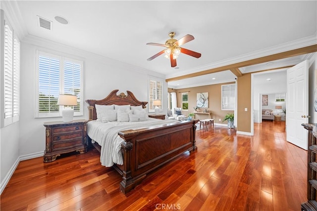 bedroom featuring hardwood / wood-style flooring, crown molding, and visible vents