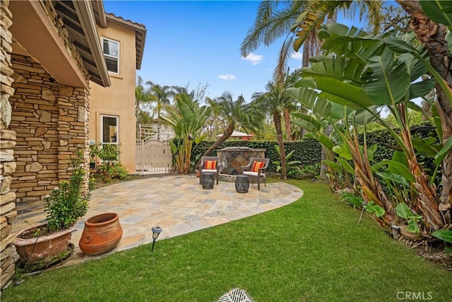view of yard featuring fence, a patio area, and a gate