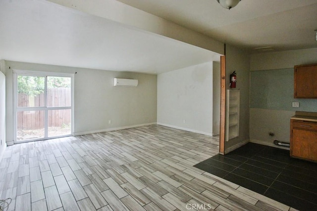 643 W Ramona Dr, Rialto, CA 92376 - kitchen with an AC wall unit, wood tiled floors, open floor plan, and brown cabinets