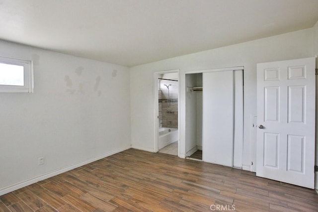 643 W Ramona Dr, Rialto, CA 92376 - unfurnished bedroom featuring wood finished floors, a closet, and ensuite bathroom