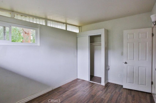 643 W Ramona Dr, Rialto, CA 92376 - unfurnished bedroom featuring wood finished floors, multiple windows, and a closet