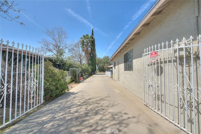 view of road featuring a gate and a gated entry