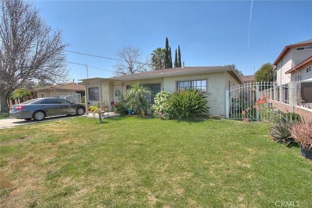 single story home featuring a front yard, stucco siding, and fence
