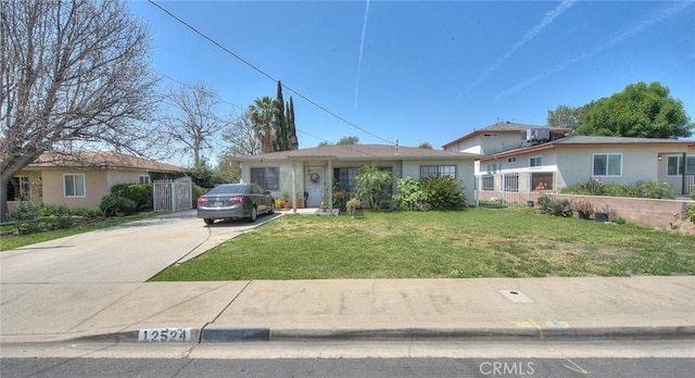 ranch-style house with driveway and a front yard