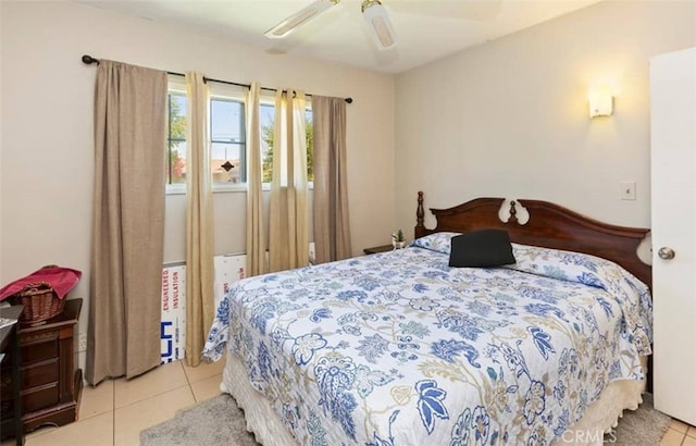 tiled bedroom featuring a ceiling fan