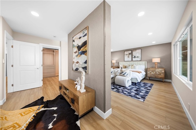 bedroom with light wood finished floors, baseboards, and recessed lighting