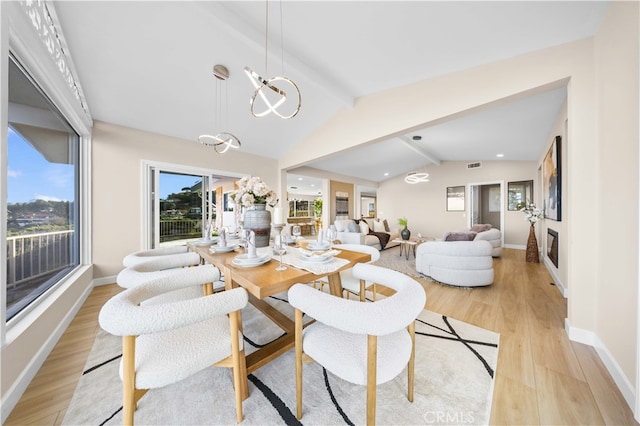 dining area featuring lofted ceiling with beams, baseboards, visible vents, a chandelier, and light wood-style floors