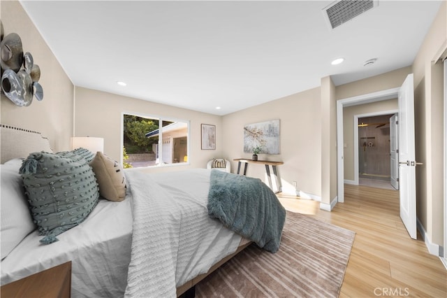 bedroom featuring baseboards, wood finished floors, visible vents, and recessed lighting