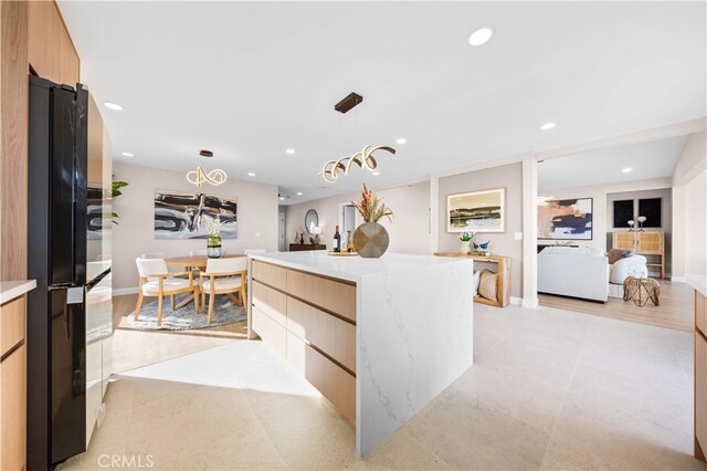 kitchen featuring hanging light fixtures, oven, modern cabinets, light countertops, and recessed lighting