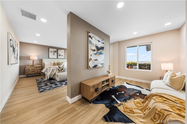interior space featuring light wood-type flooring, baseboards, visible vents, and recessed lighting