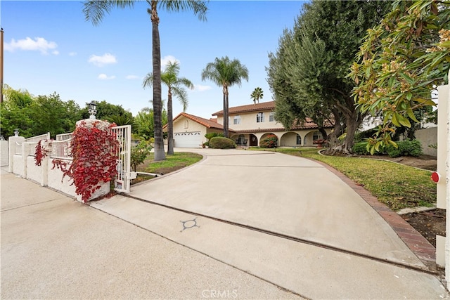 2177 W Silver Tree Rd, Claremont, CA 91711 - mediterranean / spanish-style home with driveway, a gate, stucco siding, and a detached garage
