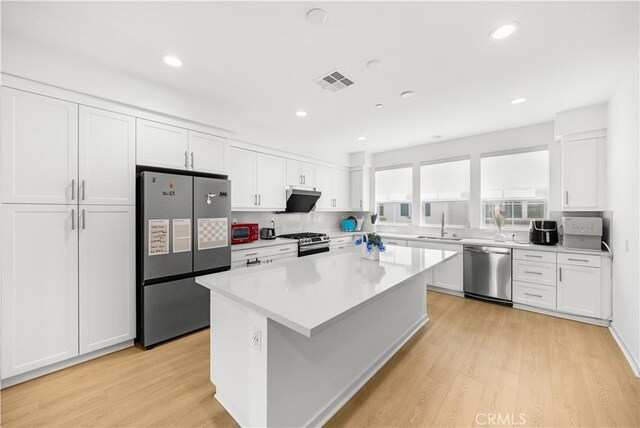 207 Colby Cir, Claremont, CA 91711 - kitchen featuring visible vents, stainless steel appliances, light wood-type flooring, and white cabinets