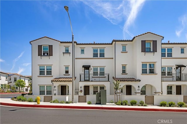 207 Colby Cir, Claremont, CA 91711 - townhome / multi-family property featuring a gate, fence, stucco siding, and a tiled roof