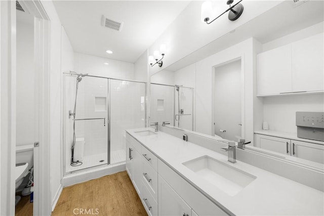 207 Colby Cir, Claremont, CA 91711 - bathroom featuring double vanity, a stall shower, wood finished floors, recessed lighting, and radiator