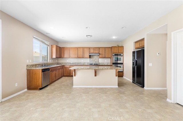 27674 Blue Topaz Dr, Menifee, CA 92585 - kitchen with brown cabinetry, a center island, appliances with stainless steel finishes, and a sink