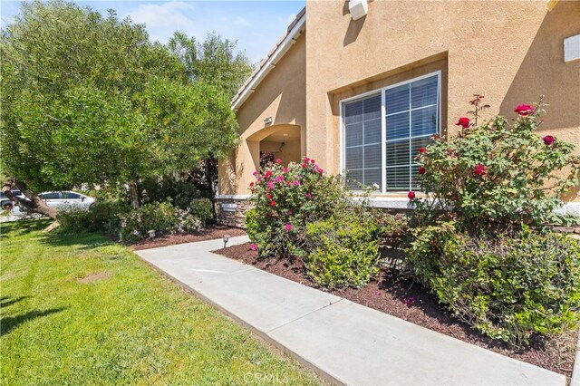 27674 Blue Topaz Dr, Menifee, CA 92585 - view of side of property featuring a lawn and stucco siding